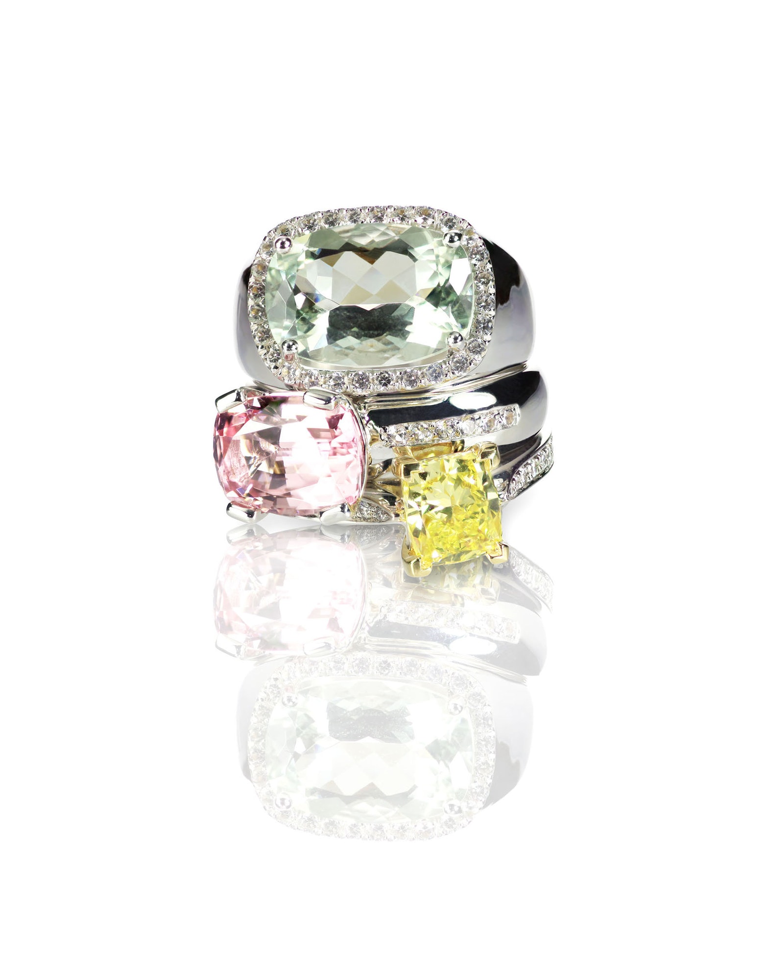 Grouping of colored gemstone diamond rings stacked